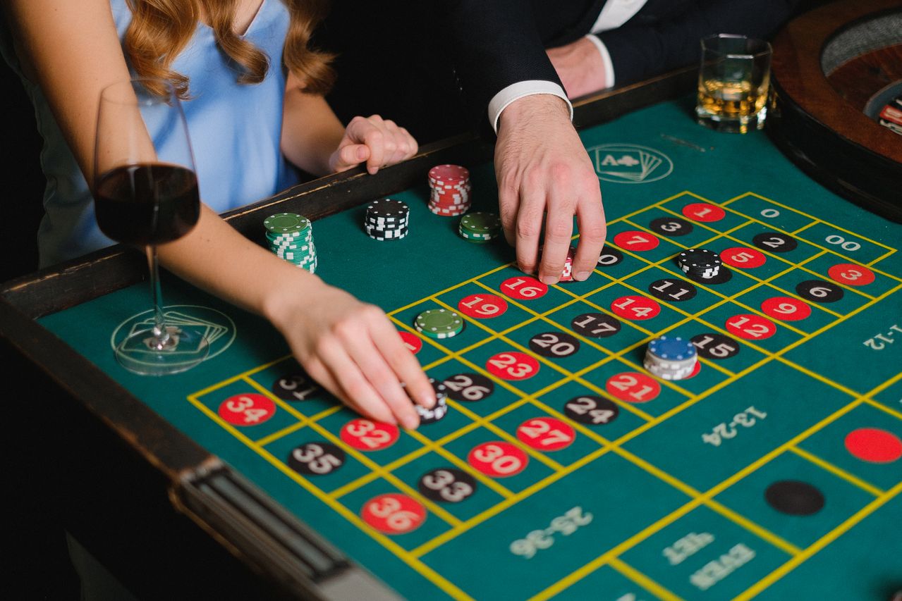 Guests placing chips on a roulette table during an evening session